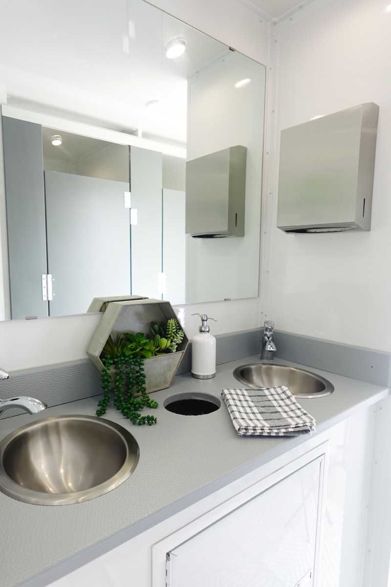 Double vanity sink with running water in luxury restroom trailer